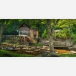 A serene landscape painting featuring a rustic mill with a waterwheel beside a gentle river, surrounded by lush forest and rocky terrain.