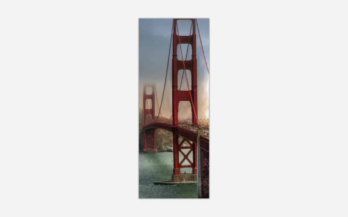 A panoramic wall art canvas featuring the Golden Gate Bridge in San Francisco during sunset with warm lighting and coastal elements.