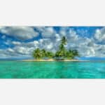 A panoramic art print of a serene tropical island with palm trees and a clear turquoise ocean under a partly cloudy sky.