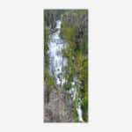 Aerial photograph of a cascading waterfall amidst green forest trees suitable for wall art.