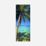A vertical art piece depicting a singular palm tree leaning over clear turquoise ocean waters with a blue sky in the background.