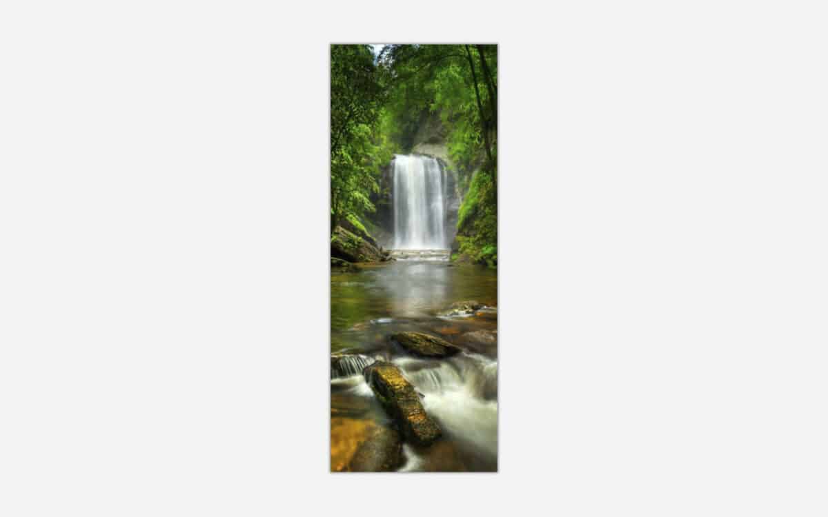 A photographic art piece of a serene waterfall cascading into a calm river surrounded by lush greenery.