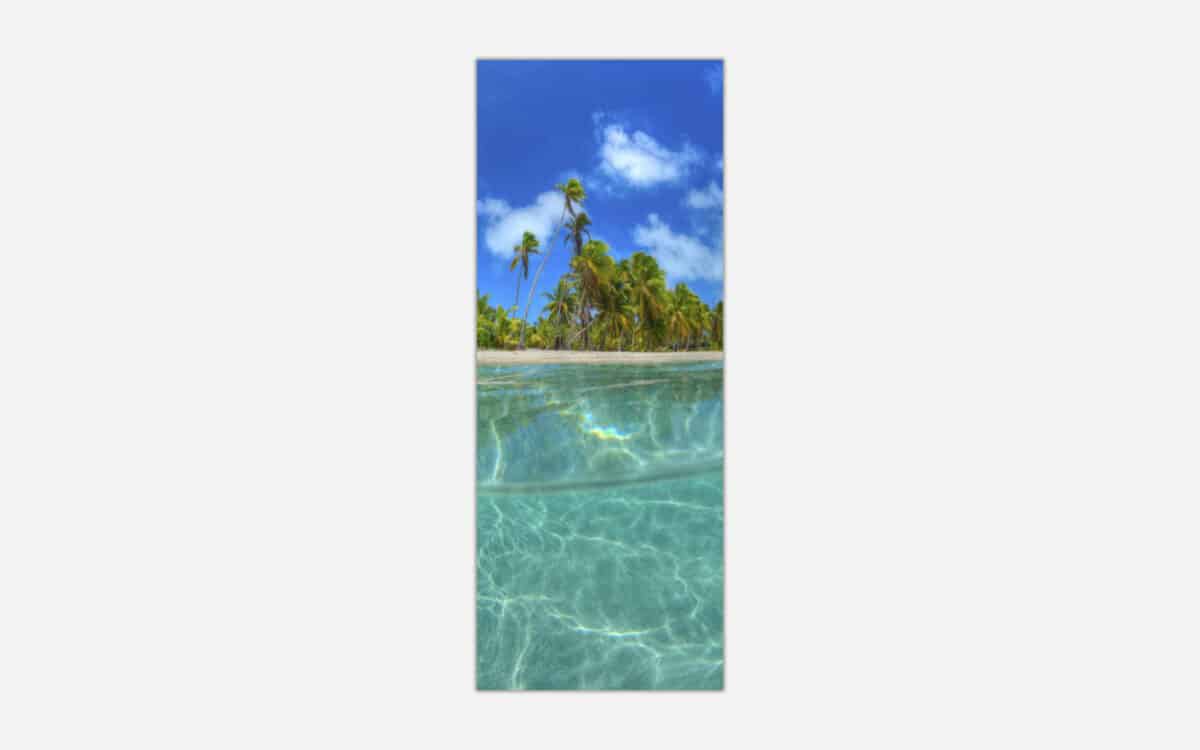 A panoramic art print featuring a pristine tropical beach with clear turquoise waters, lush palm trees, and a sunny blue sky.