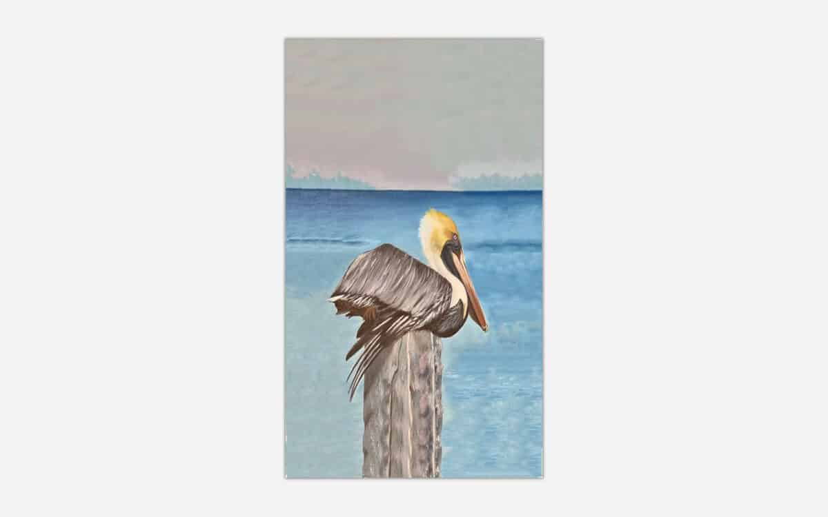 A painting of a pelican perched on a post with a calm blue ocean in the background.