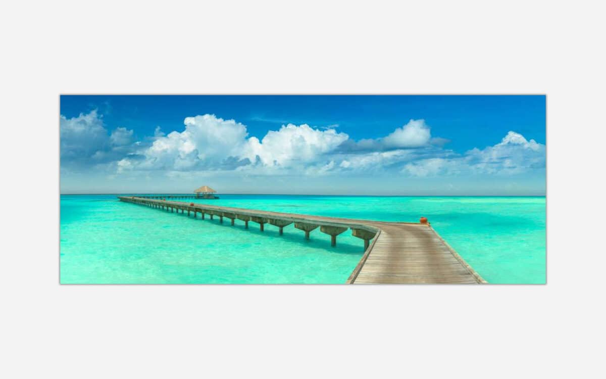 A landscape painting depicting a wooden pier extending into a tranquil turquoise ocean under a blue sky with fluffy clouds.