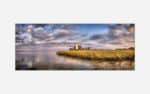 A scenic artwork depicting a white lighthouse on a grassy coastal area with a serene waterfront and a sky filled with clouds at sunset.