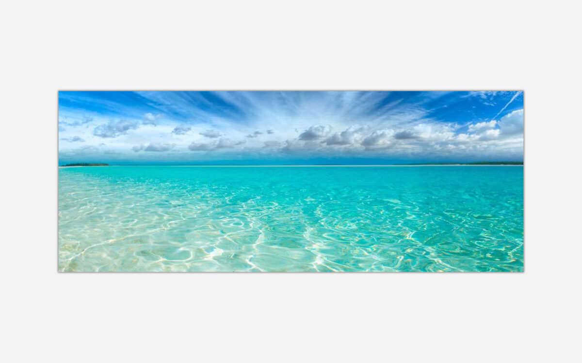 A canvas print featuring a serene tropical beach scene with clear turquoise water and a blue sky with scattered clouds.