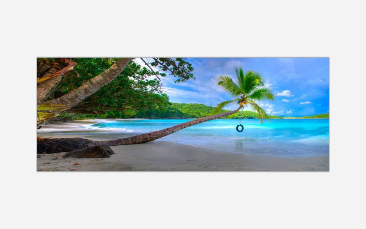 Alt text: "A vibrant art print of a serene tropical beach with crystal-clear turquoise waters, a single palm tree with a tire swing, and a bright blue sky."