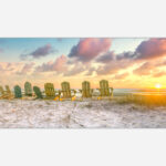 beachside sunset art with a line of chairs